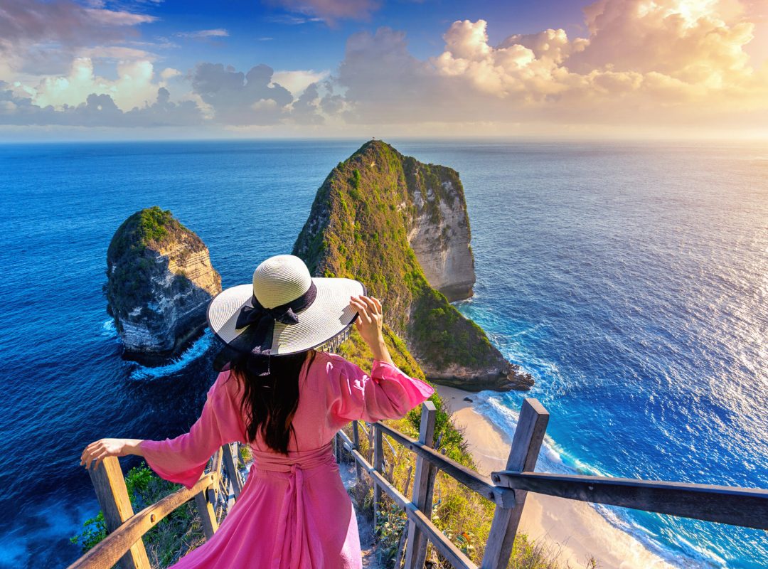 Woman walking at Kelingking Beach in Nusa penida island, Bali, Indonesia.